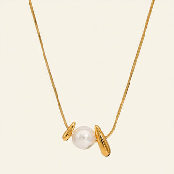 Gold necklace with a pearl pendant on a white background