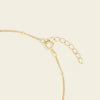 Gold chain necklace on a beige background