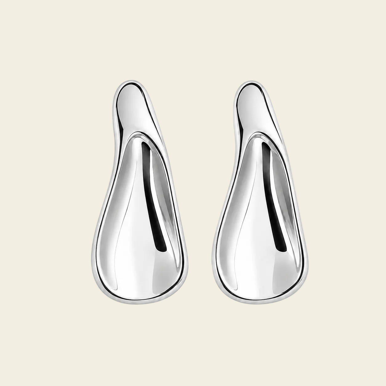 A pair of polished silver teardrop-shaped earrings with a smooth, reflective finish, displayed on a light beige background.