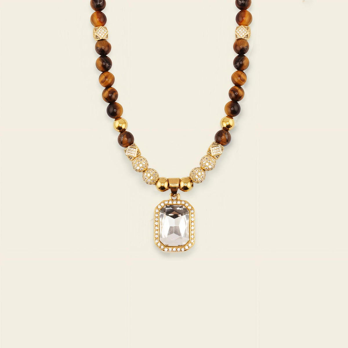 Necklace with brown beads and a gold pendant on a beige background