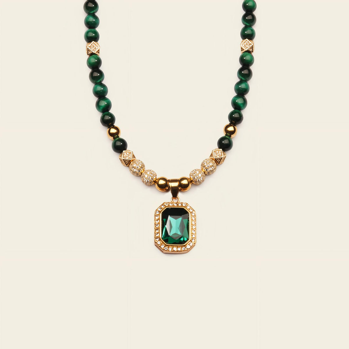 Necklace with green gemstone pendant on a beige background