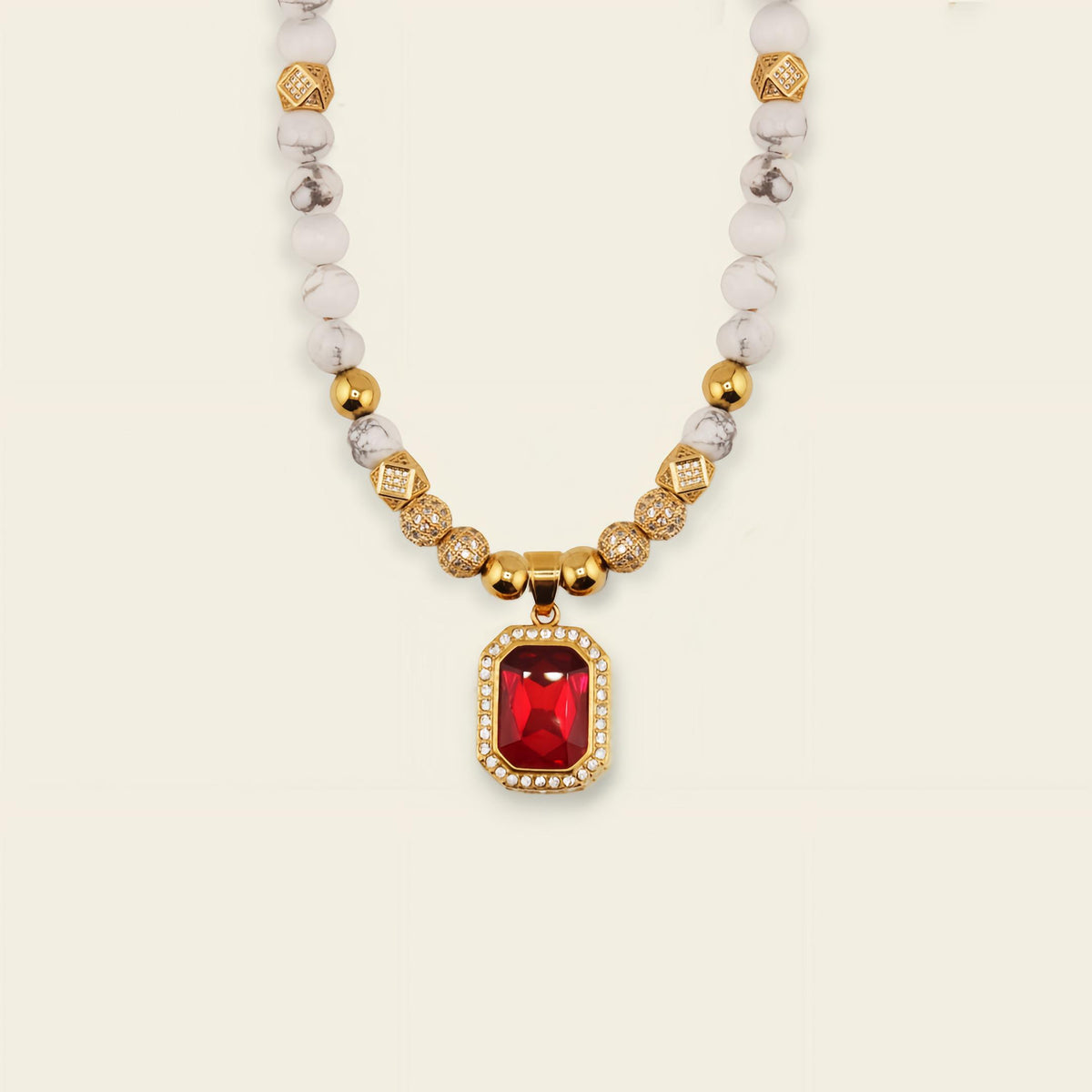 Necklace with red gemstone pendant on a beige background