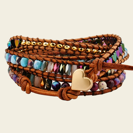 Multistrand beaded bracelet with a heart charm on a beige background