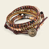 Multistrand beaded bracelet with a decorative button on a beige background