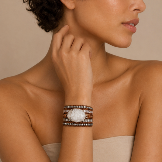 Woman wearing a bracelet with a large stone on a beige background