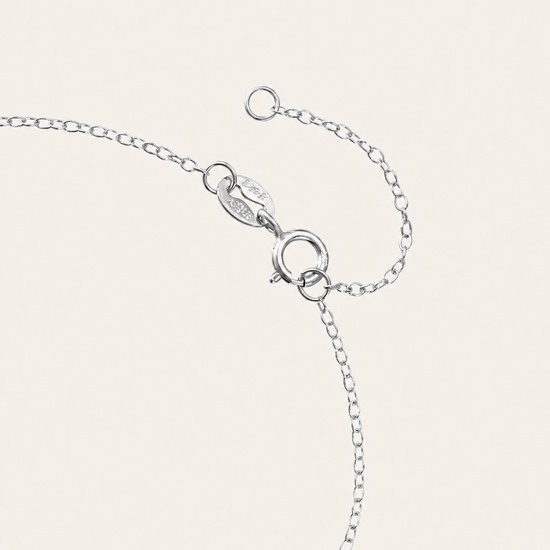 Silver bracelet on a light beige background
