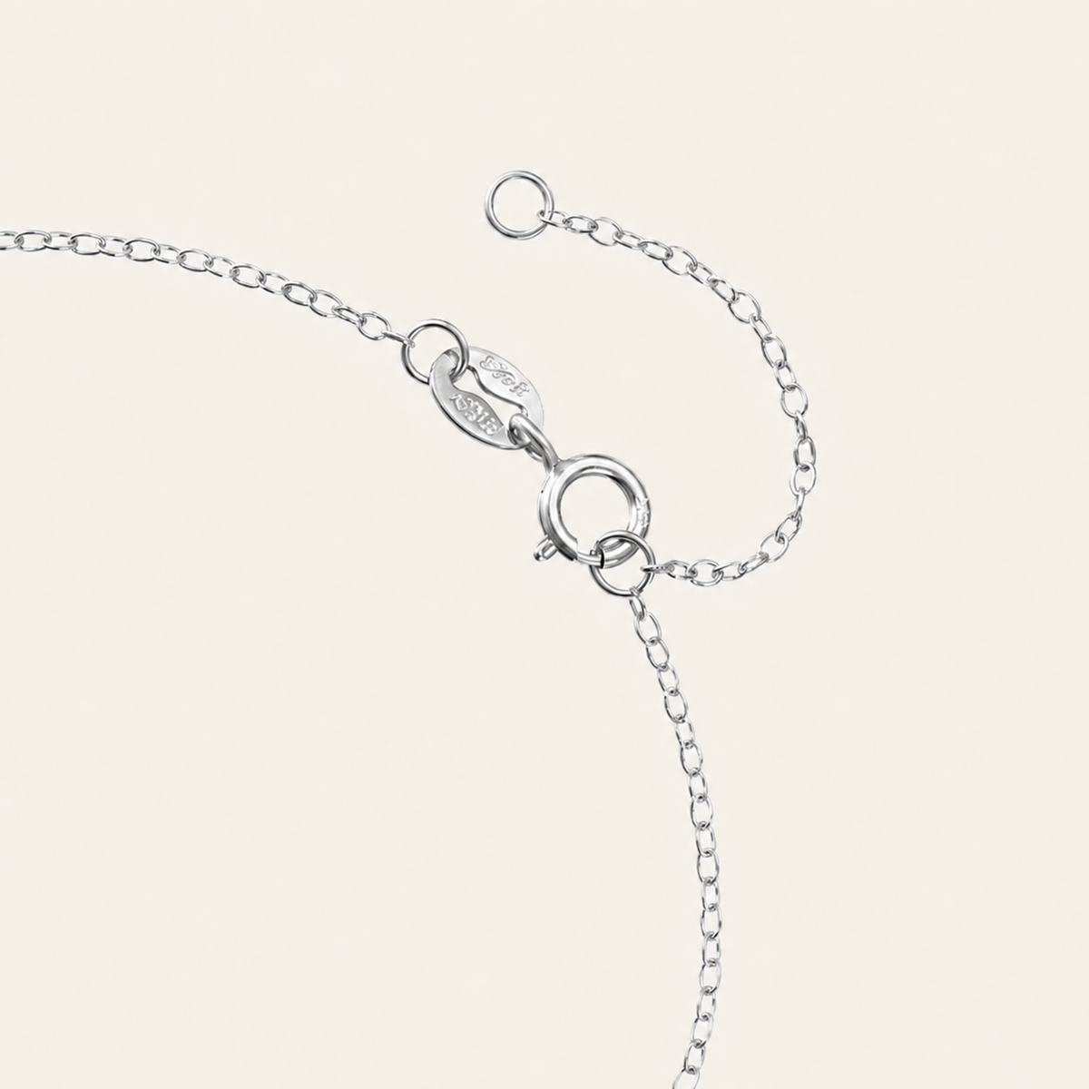Silver bracelet on a light beige background
