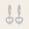 Heart-shaped silver earrings with clear stones on a light gray background