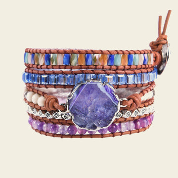 Woman on a beach wearing colorful bracelets with a blurred background