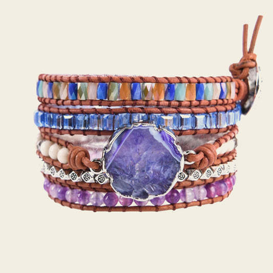 Woman on a beach wearing colorful bracelets with a blurred background