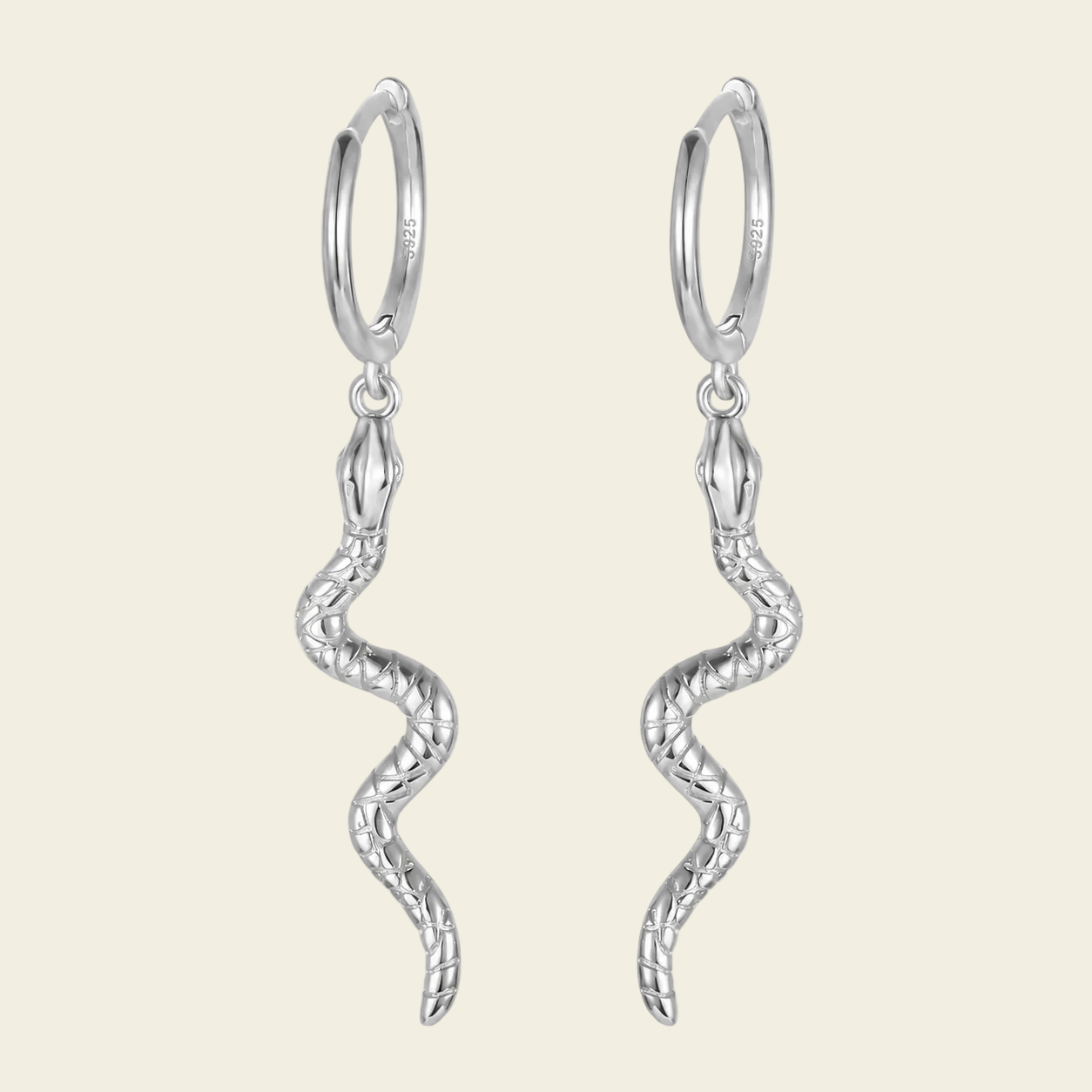 Silver hoop earrings with wavy designs on a light beige background