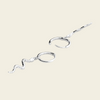 A pair of silver-toned ear cuffs with textured wavy dangling chains, displayed on a solid light beige background.