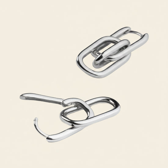  metallic hooks on a beige background
