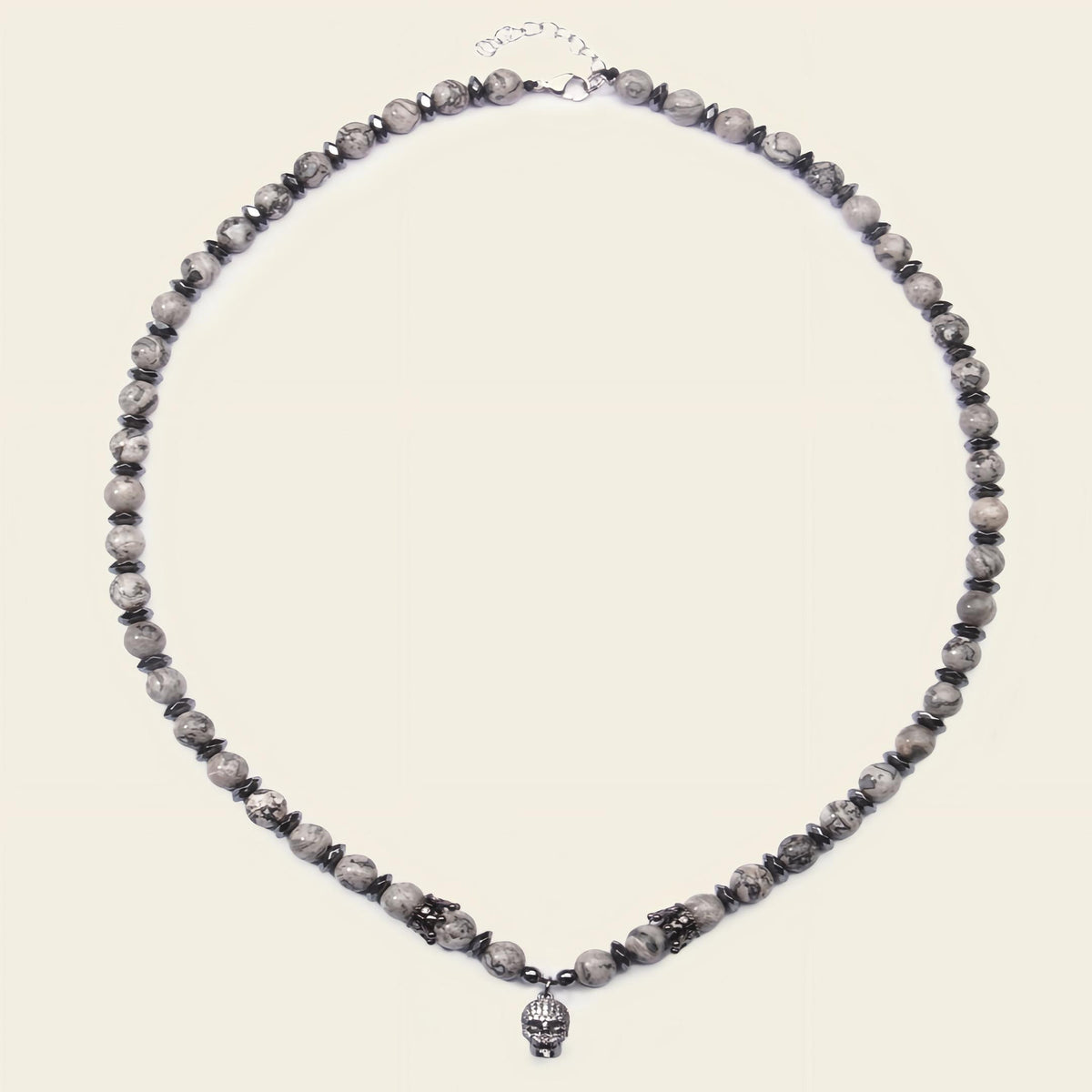 Necklace with gray beads on a beige background