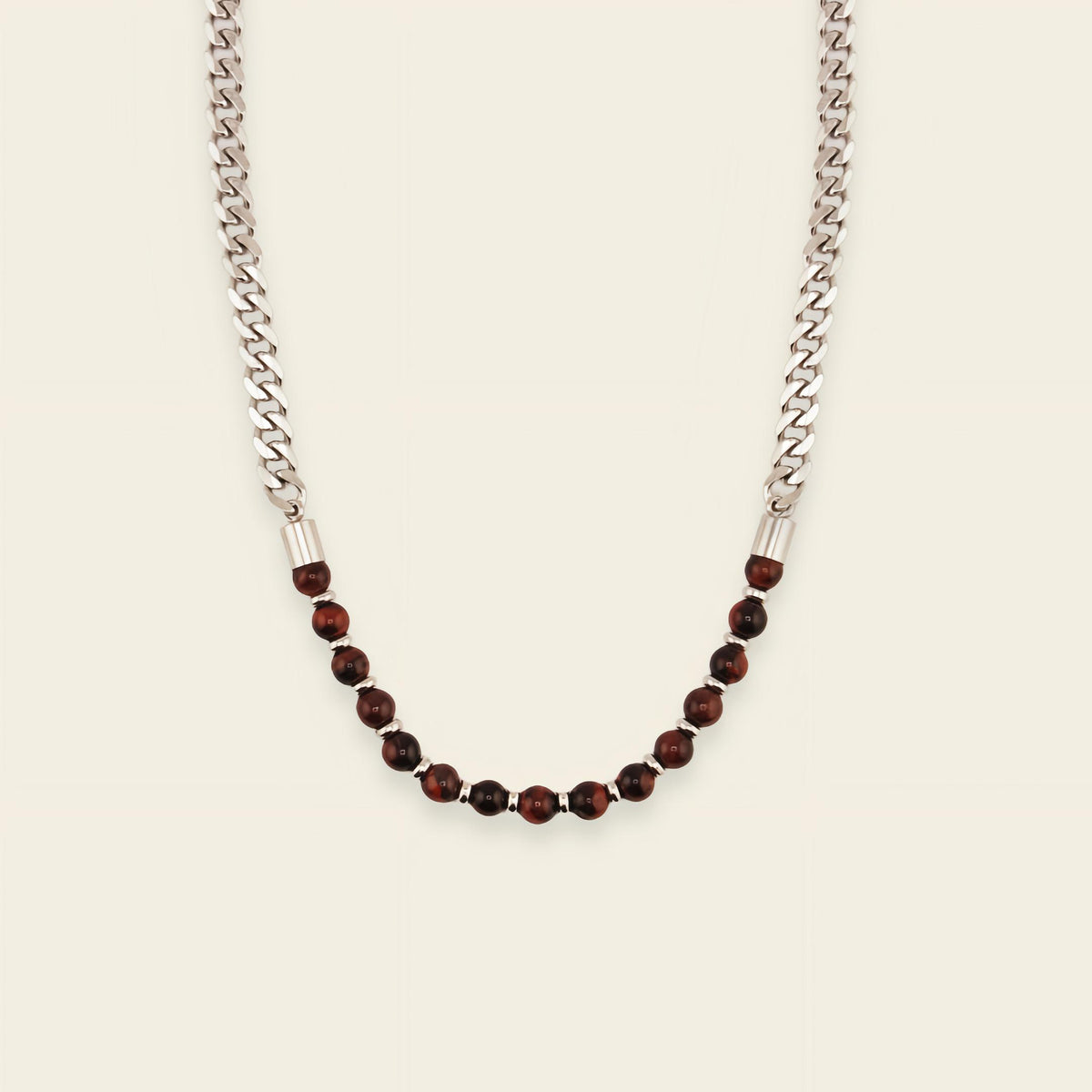 Necklace with silver chain and brown beads on a beige background