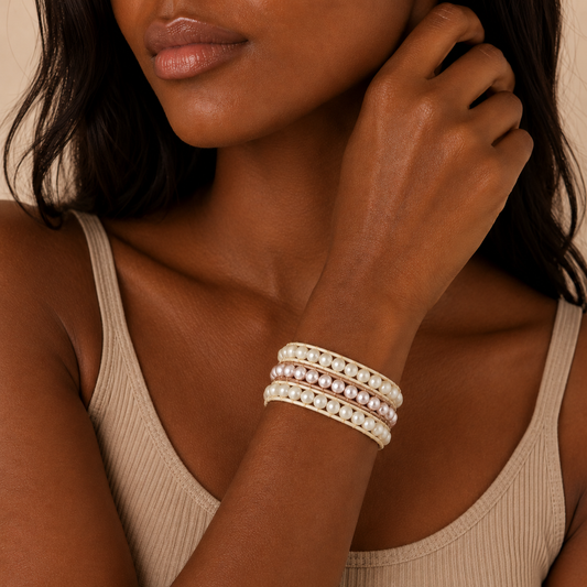 Woman wearing pearl bracelets on a neutral background