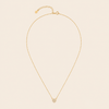 Gold necklace with a pendant on a beige background