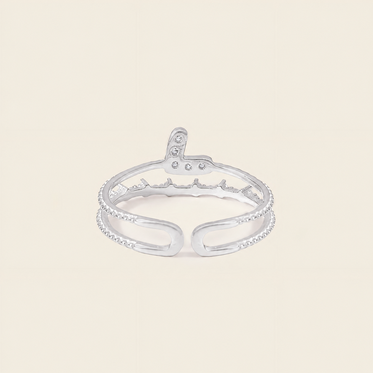 Silver ring with small stones on a light beige background