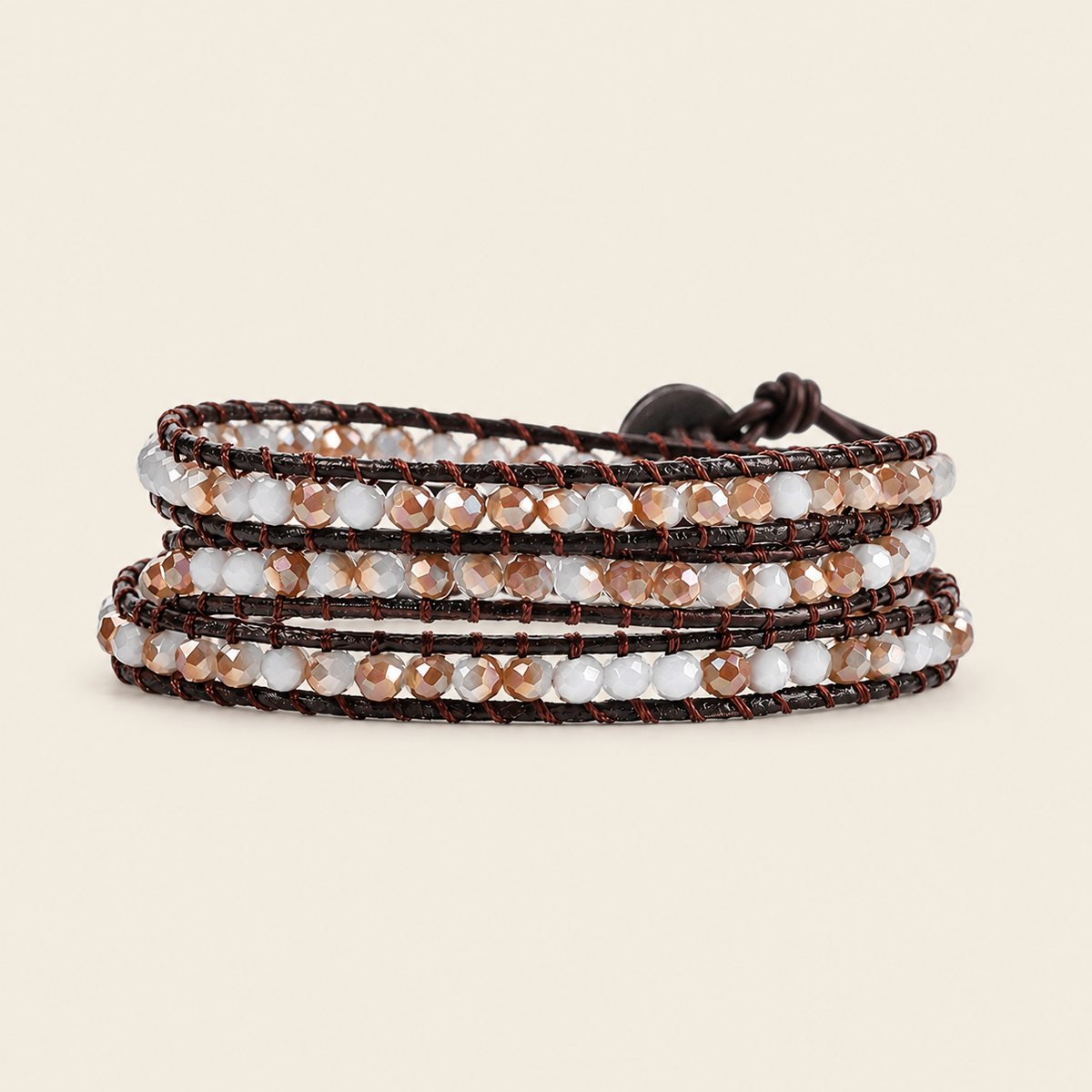 A multi-strand wrap bracelet featuring dark brown cord, clear faceted beads, and metallic rose gold beads, shown on a solid light beige background.
