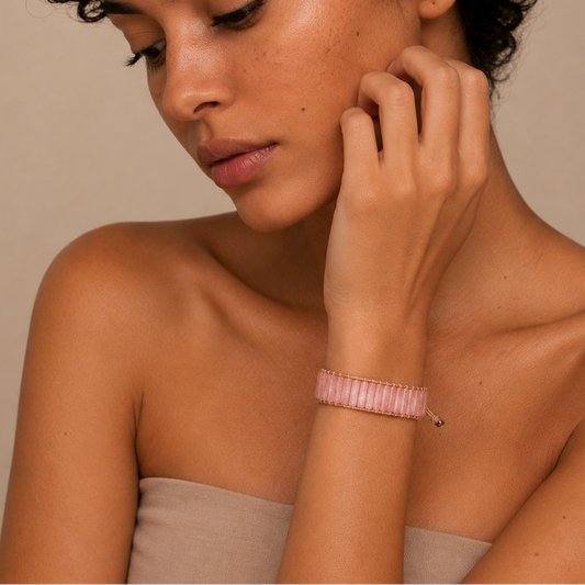 Woman with a pink bracelet on a beige background