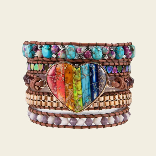 Multistrand bracelet with a heart-shaped rainbow stone on a beige background