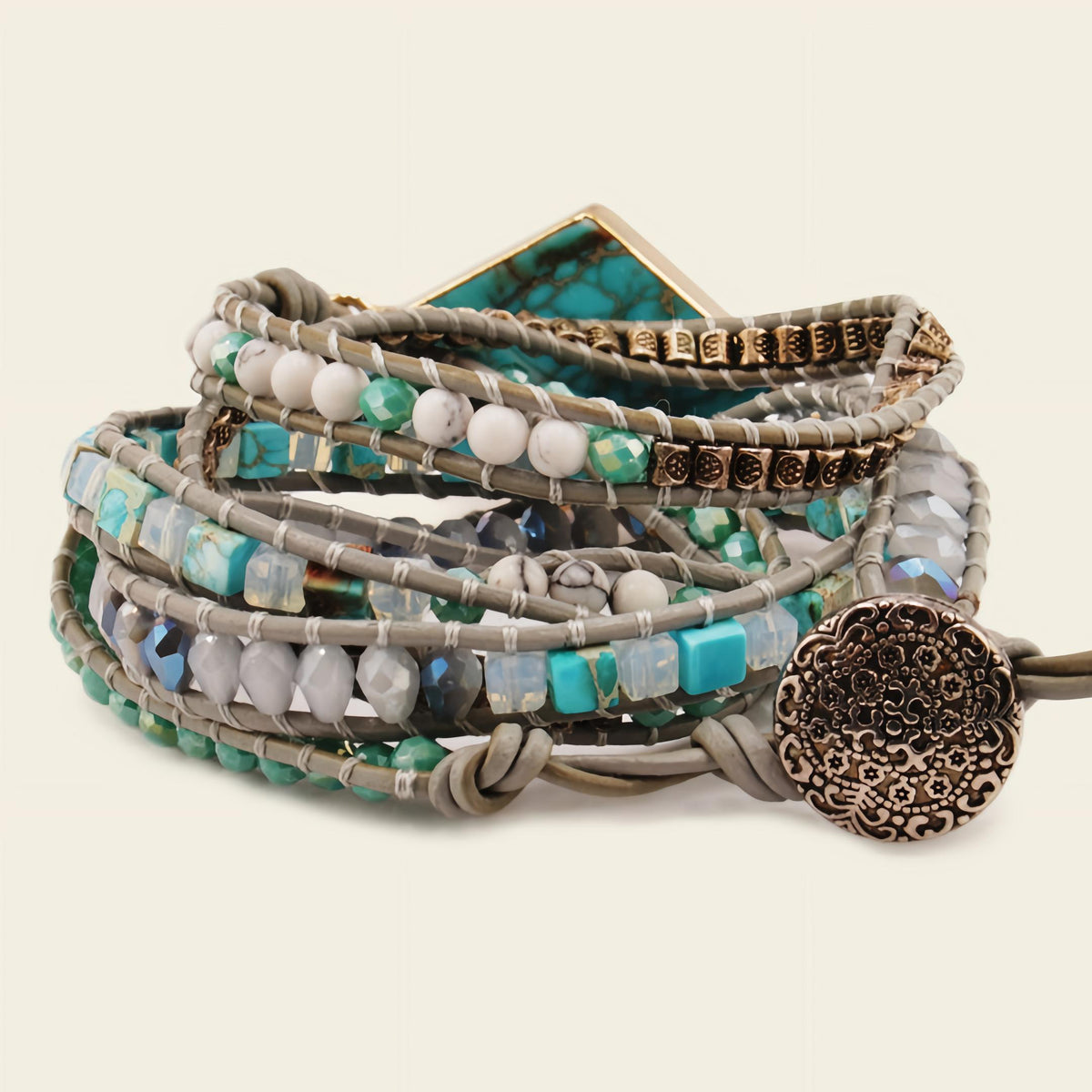 Multistrand beaded bracelet with decorative clasp on a light background