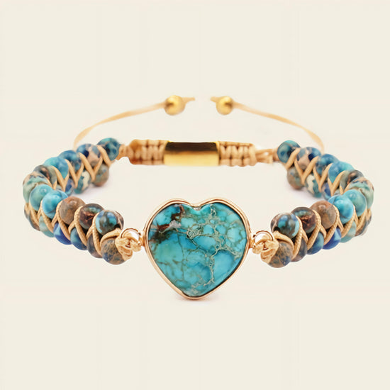 Turquoise beaded bracelet with a heart-shaped turquoise charm on a beige background