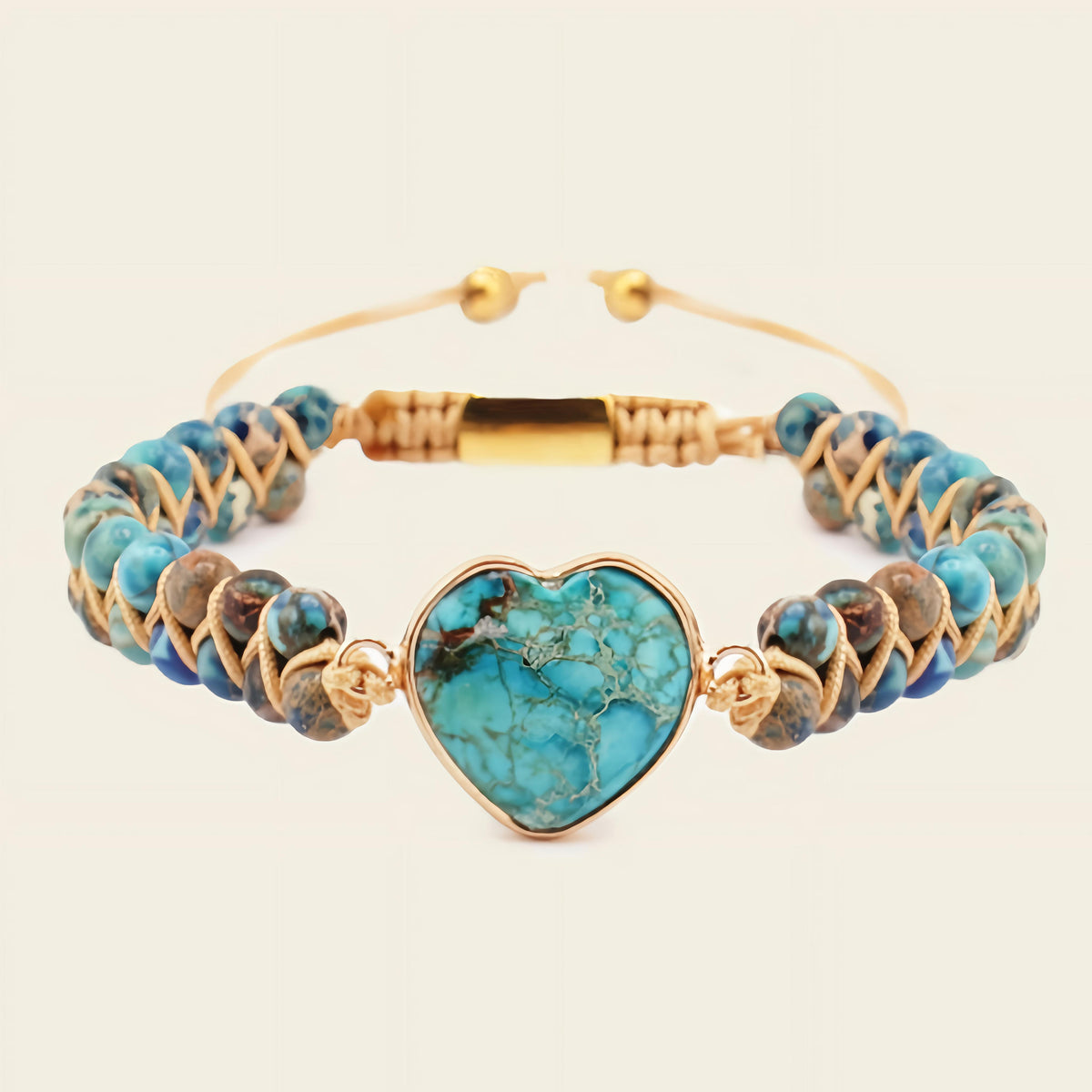Turquoise beaded bracelet with a heart-shaped turquoise charm on a beige background