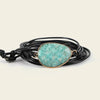 Turquoise stone bracelet on a wrist against a neutral background