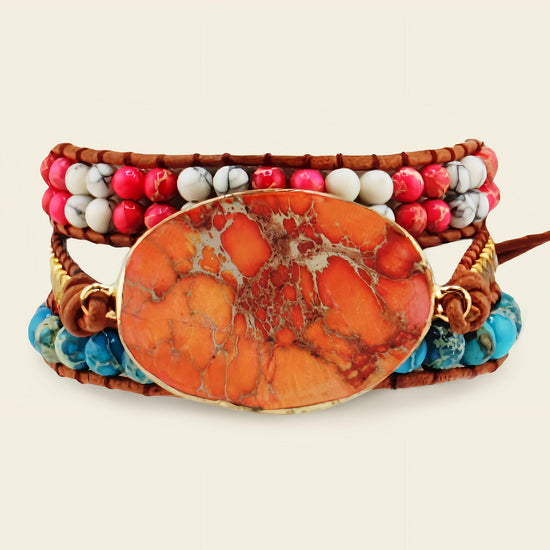 Multistrand bracelet with an orange stone centerpiece on a light background