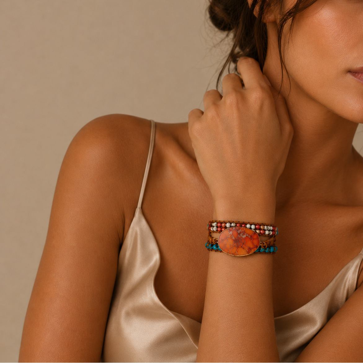 Woman wearing a colorful beaded bracelet on a neutral background