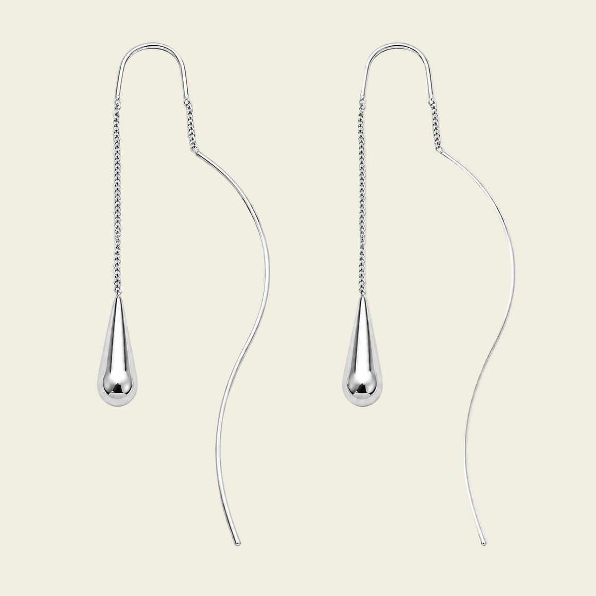 A pair of silver teardrop dangle earrings with curved wire hooks and a short chain, displayed on a light beige background.