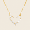 Gold necklace with a heart-shaped pendant on a beige background