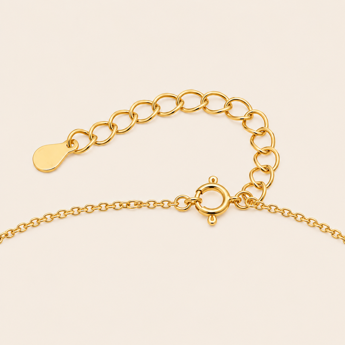 Gold chain clasp on a beige background