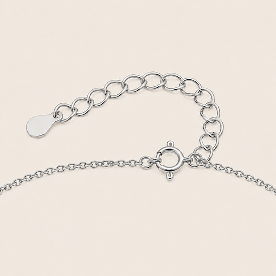 Silver chain Clasp on a light beige background
