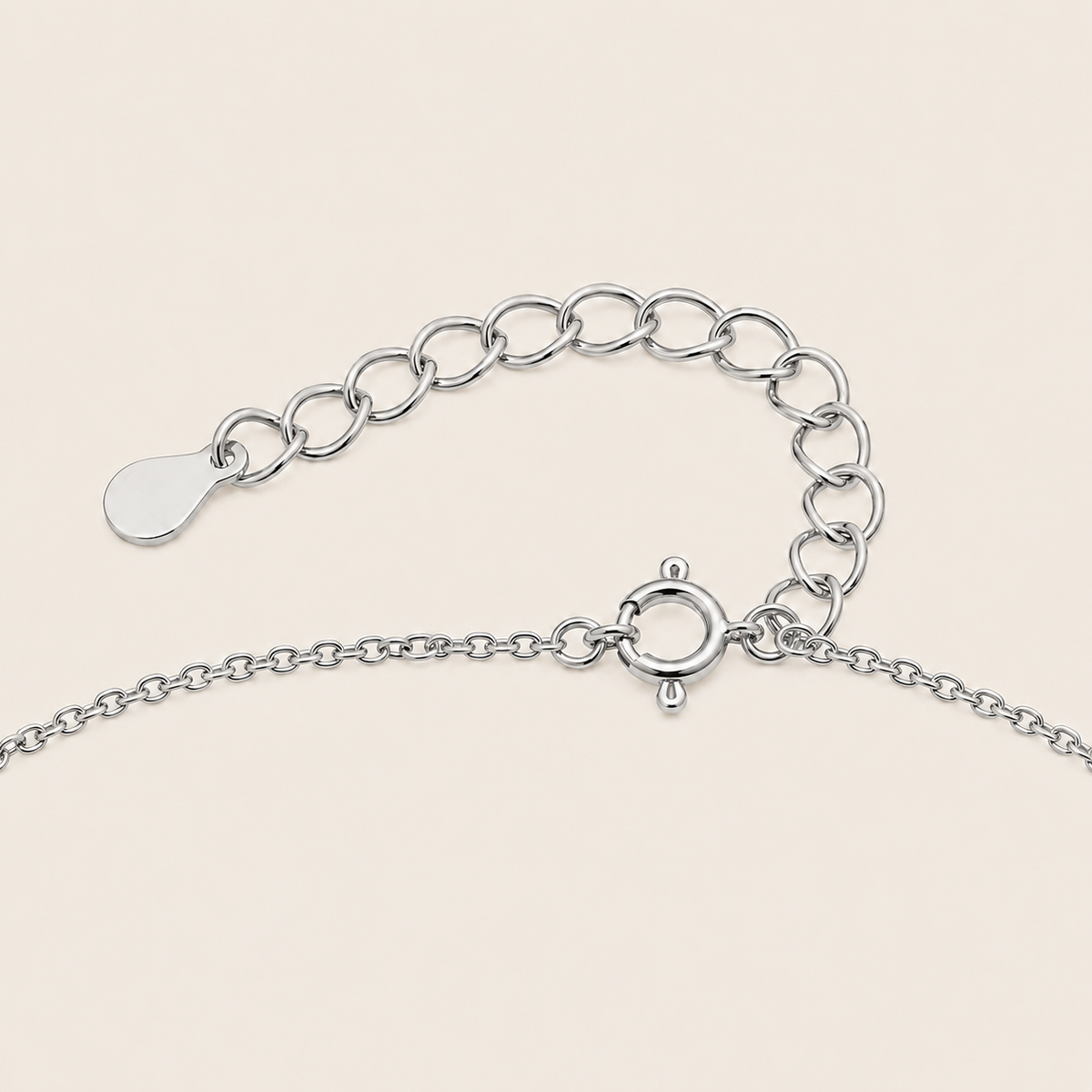 Silver chain Clasp on a light beige background