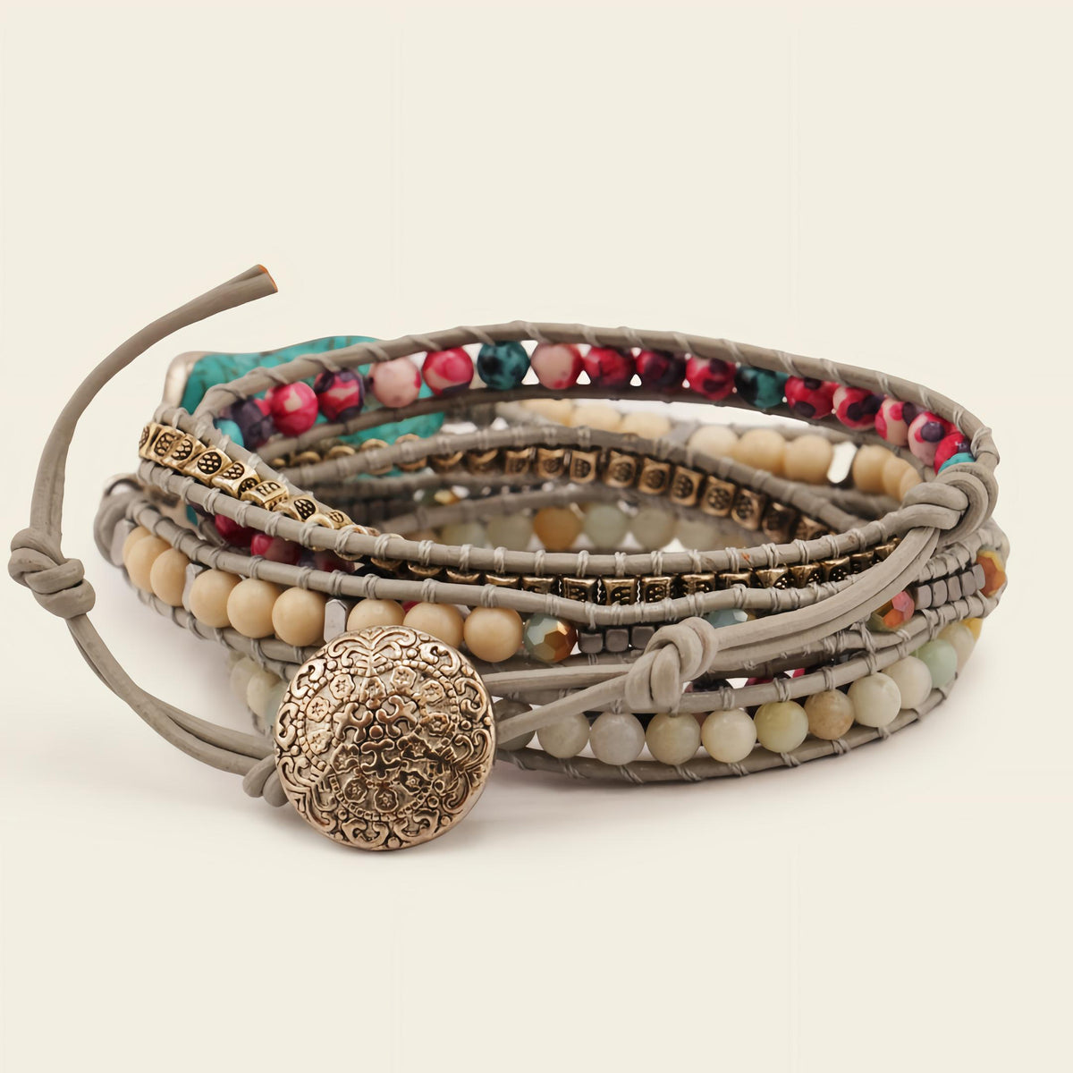 Multistrand beaded bracelet with decorative button clasp on a light background