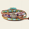 Multistrand beaded bracelet with a decorative button clasp on a beige background