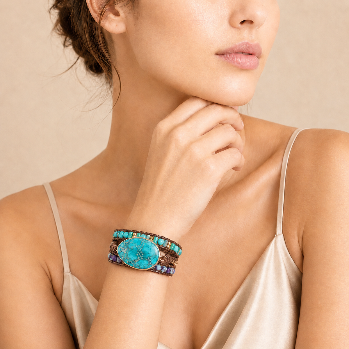 Woman wearing a turquoise bracelet on a beige background