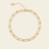 Gold chain bracelet on a beige background