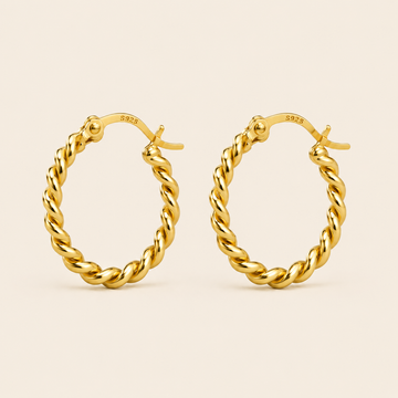 A pair of gold hoop earrings with a twisted rope design, shown on a light beige background. The inside of the hoops shows a '925' sterling silver hallmark.