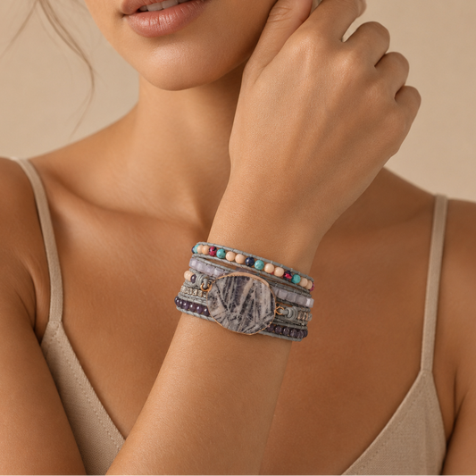 Woman wearing a bracelet with beads on a beige background