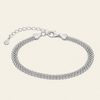 A silver multi-strand mesh chain bracelet with a lobster clasp and extender chain, displayed on a light cream background.