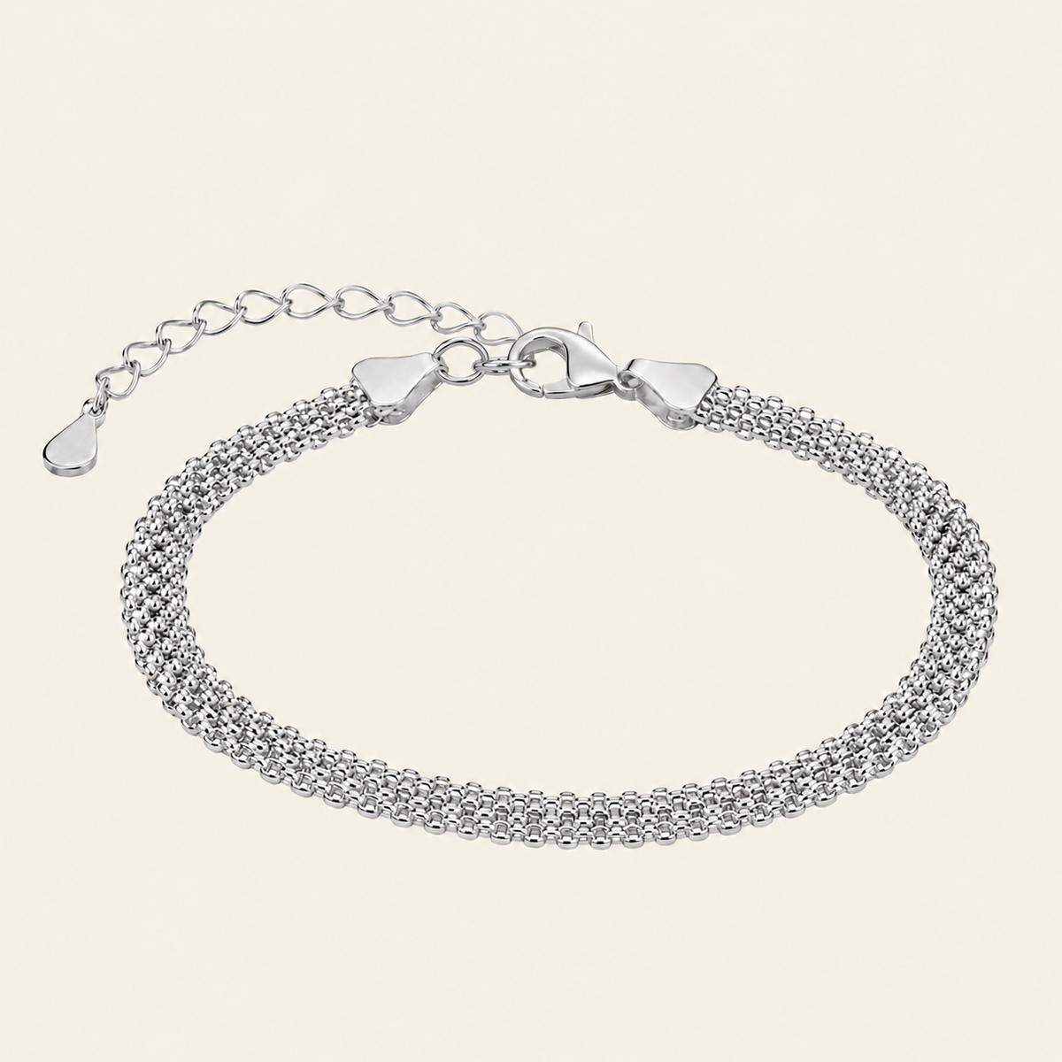 A silver multi-strand mesh chain bracelet with a lobster clasp and extender chain, displayed on a light cream background.