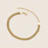 A gold chain bracelet with a textured mesh-like woven band, a lobster clasp, and an adjustable extender chain with heart-shaped links, shown on a light beige background.