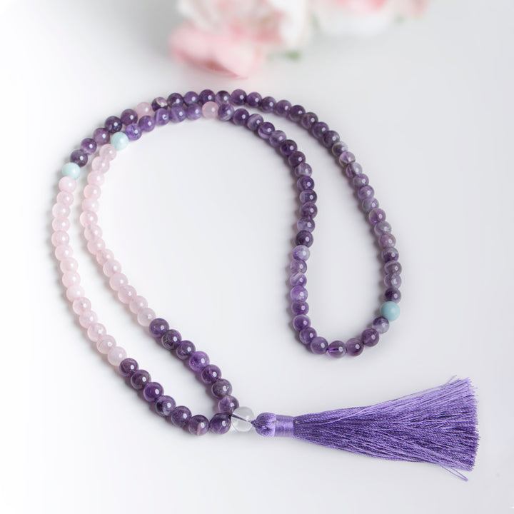 Handmade necklace with alternating amethyst and rose quartz beads, finished with a silky purple tassel