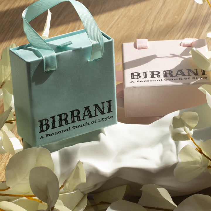 Birrani jewellery packaging with pastel gift boxes and ribbon handles, featuring elegant branding for stylish handmade accessories