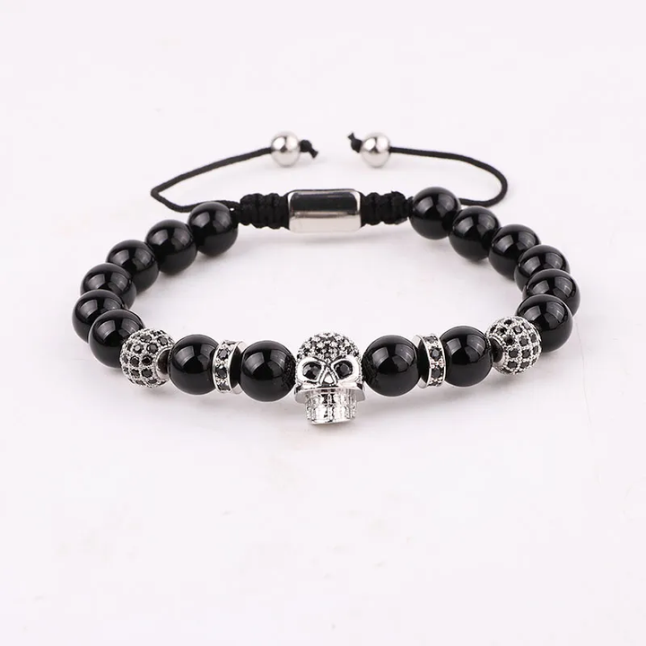 Handmade adjustable bracelet with black onyx beads and a silver zircon skull charm, a stylish gothic-inspired accessory for men and women.