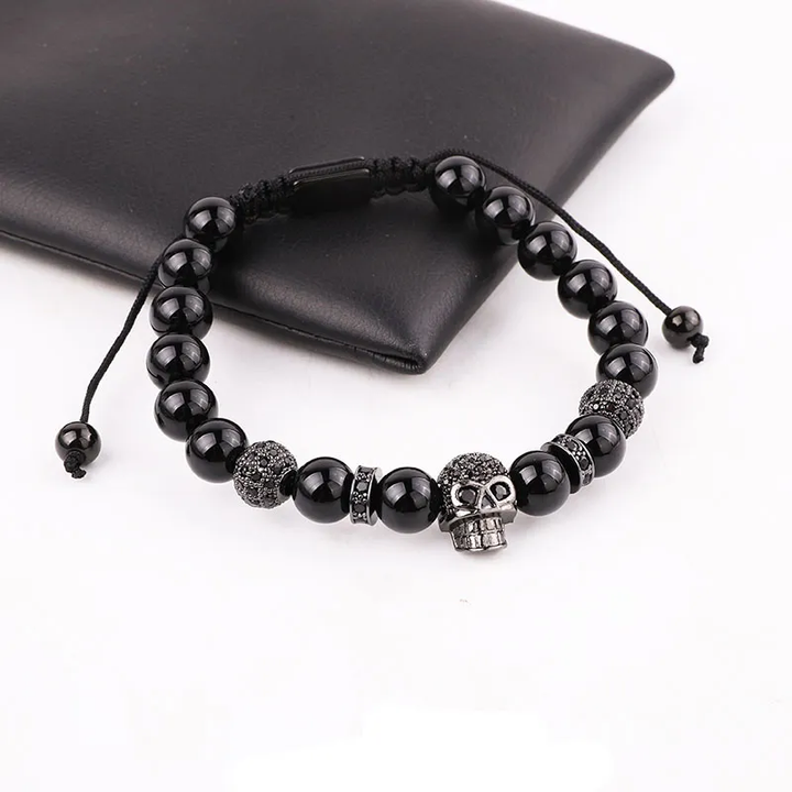 Handmade adjustable bracelet featuring black onyx beads and a silver zircon skull charm, a stylish accessory for gothic fashion.