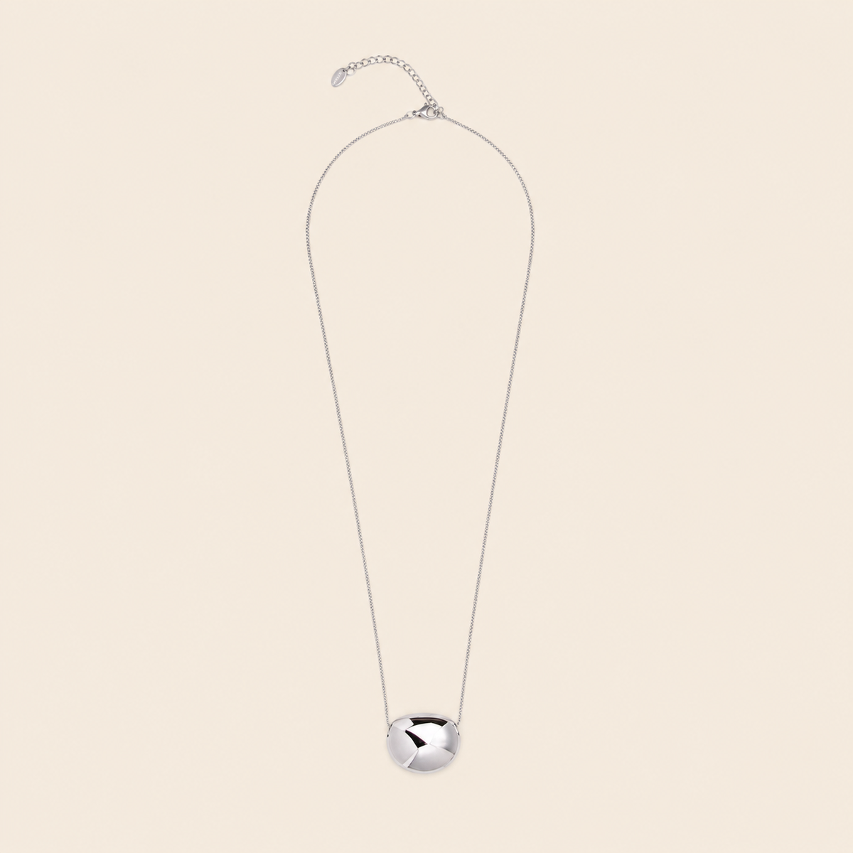 Molten Pebble Necklace with a fine chain and rounded pebble-shaped pendant in silver finish